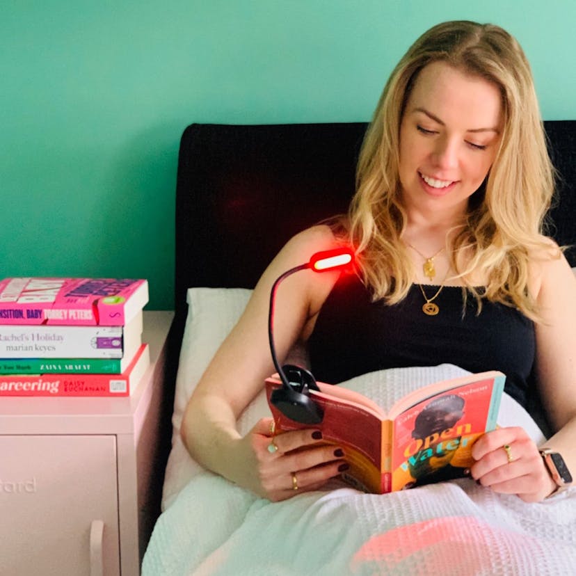Reading books in bed with a red light reading light